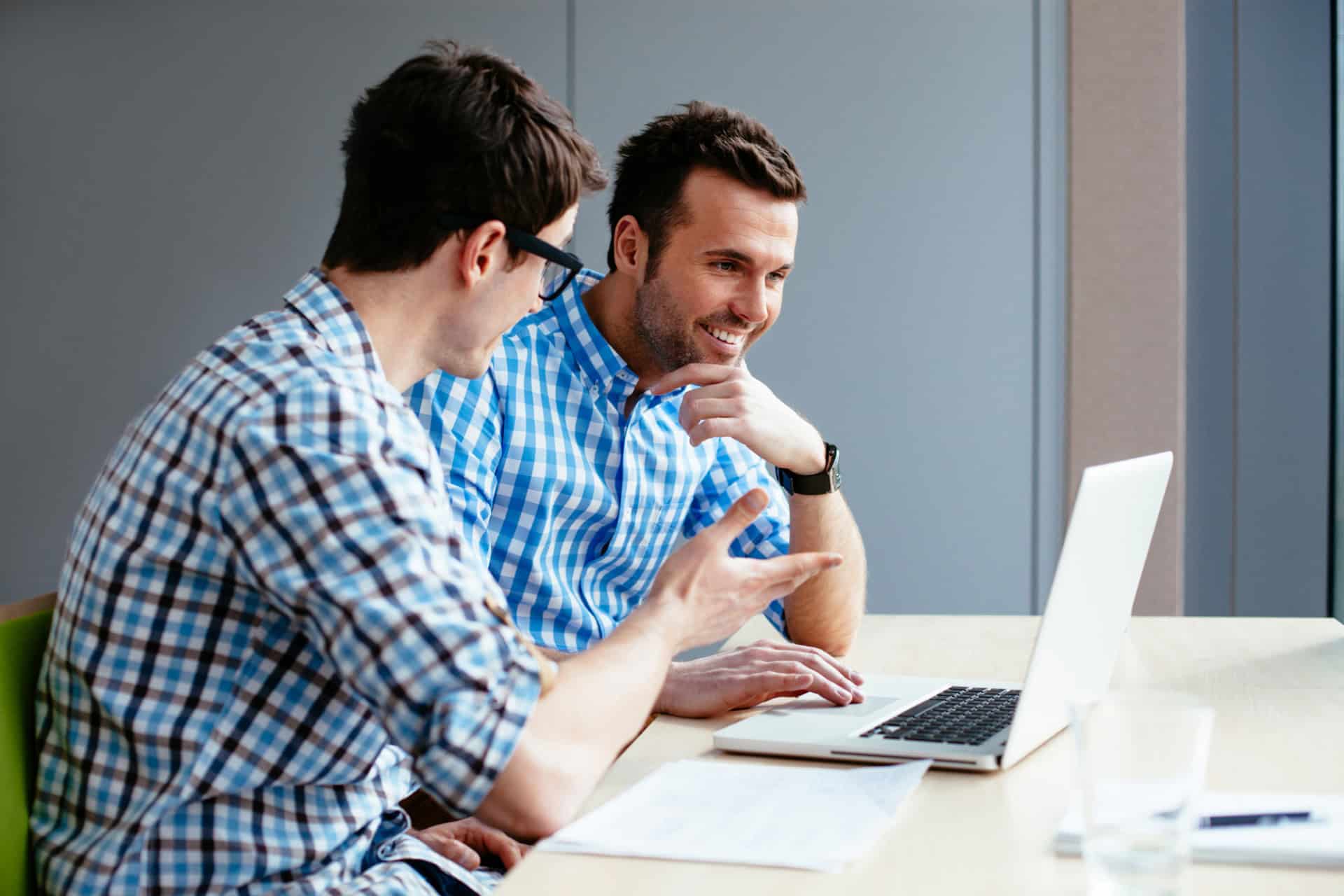 Web designers at office working with laptop