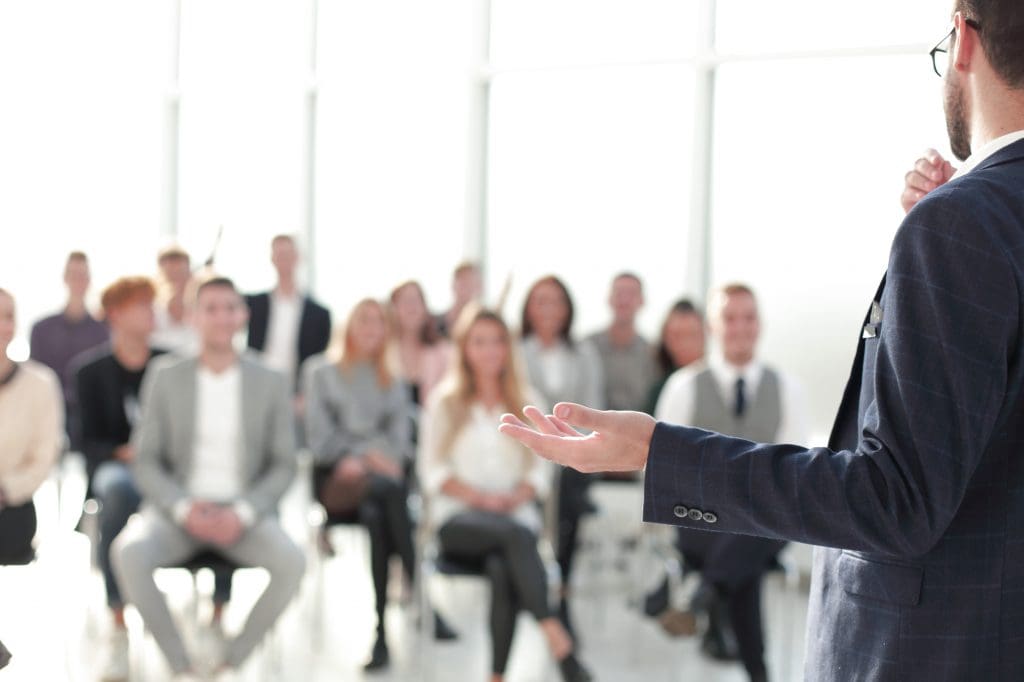 close up. speaker standing in front of the audience in the conference room. photo with copy space