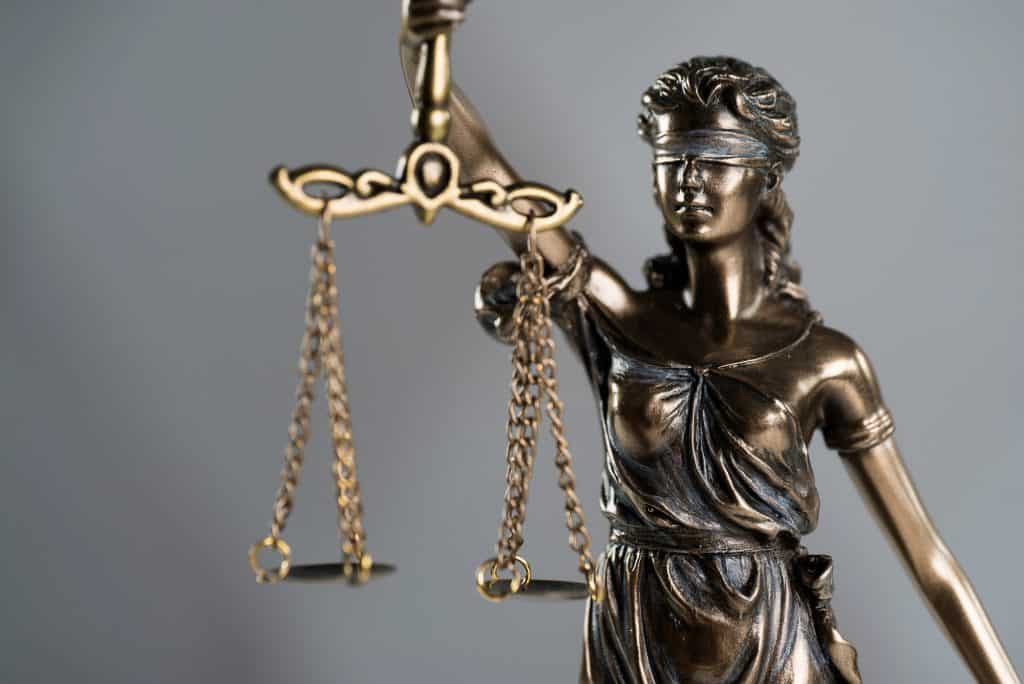 Lady justice, blindfolded, isolated on white.